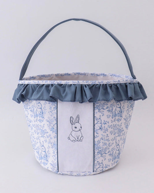 Fabric basket with floral pattern and embroidered bunny design on a white background
