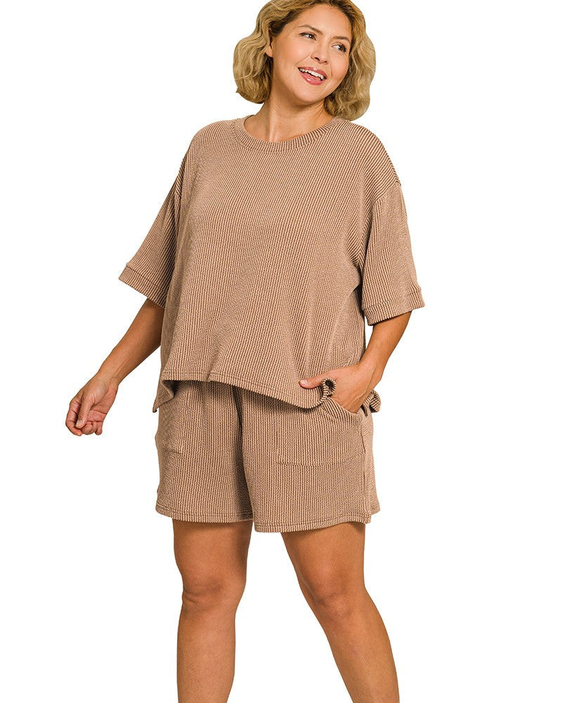 Woman wearing a beige outfit with a top and shorts on a white background